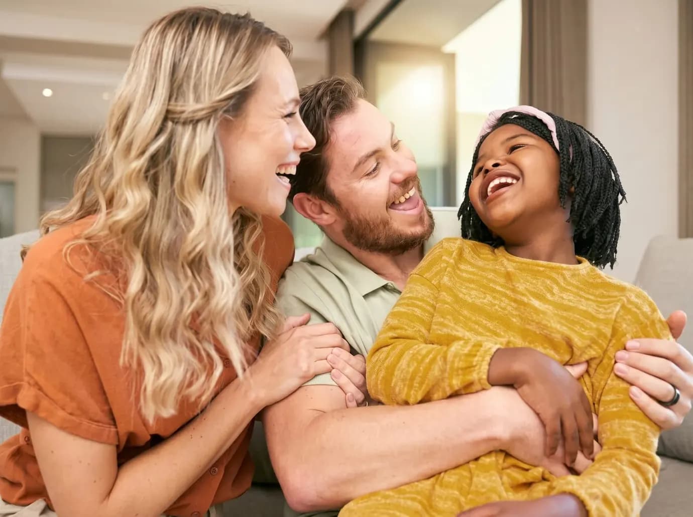 A multigenerational Banff family sharing a warm, laughing moment together